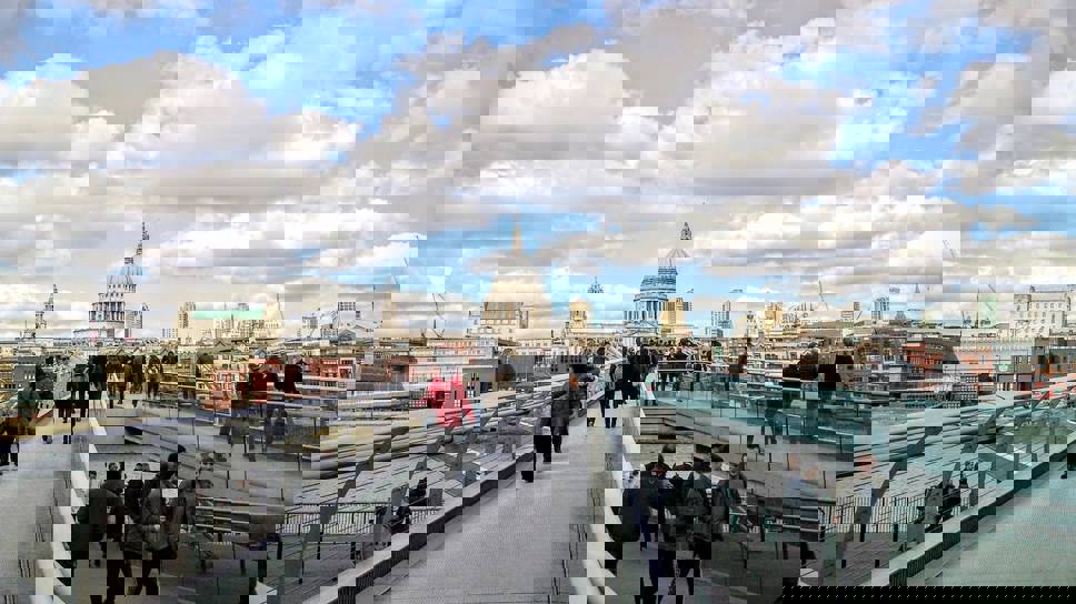People walking over Millennium bridge