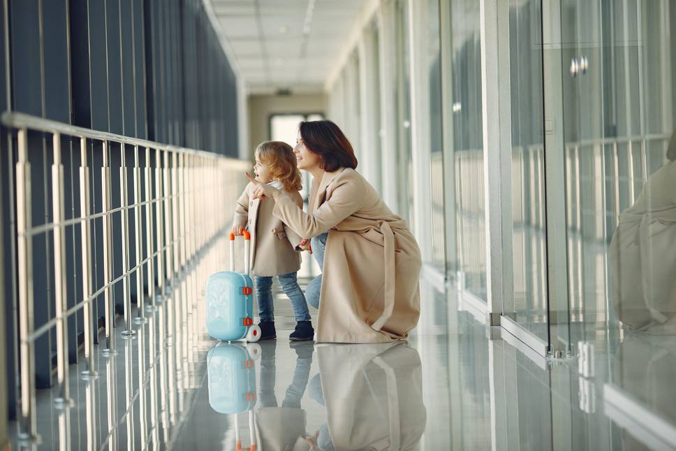 Woman and child with a suitcase