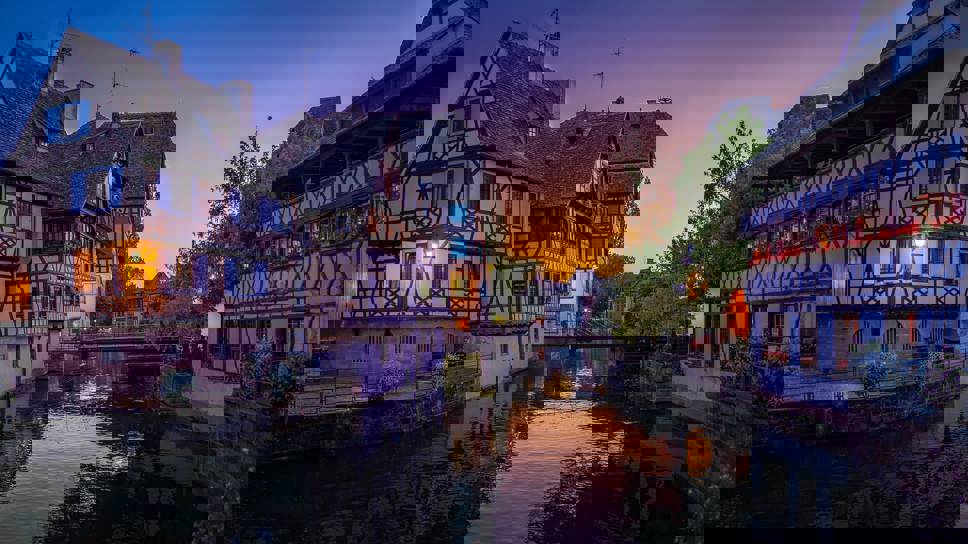 Buildings and bridge near river in Strasbourg